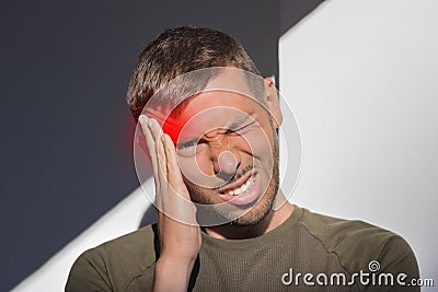 Man touching his temple and having strong tension headache. Cluster headache Stock Photo