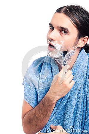 Young man in towel shaving Stock Photo