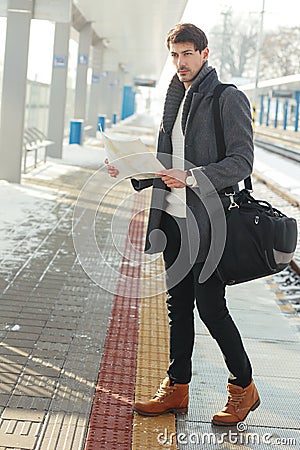 Young man at train station Stock Photo