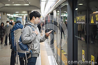 Young man traveling to Korea, male waiting for subway. Stock Photo