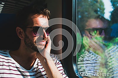 Young man traveling on a train Stock Photo