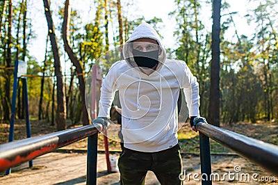 Young man Trying To Do Sport During Coronavirus Crises Despairing Of The World Stock Photo