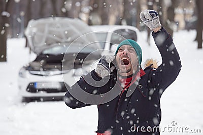 Young man is under stress because his broken down car on snow da Stock Photo