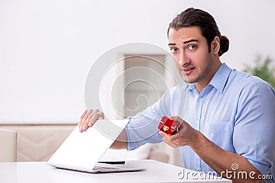 Young man in unrequited love concept Stock Photo