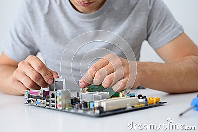 Man upgrades processor on computer motherboard Stock Photo