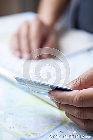 Young man using a credit card to book a trip Stock Photo