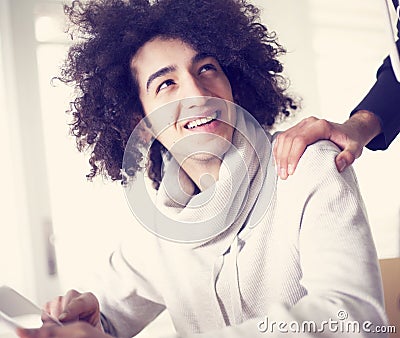 Young man using digital tablet and shows his friend Stock Photo