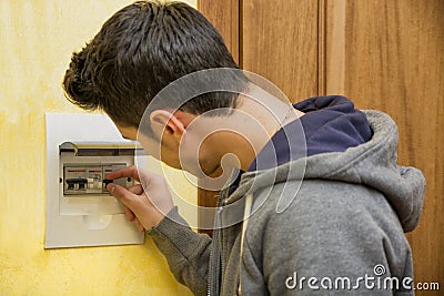 Young man using an electronic control panel Stock Photo