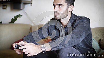 Young man using joystick or joypad for videogames Stock Photo