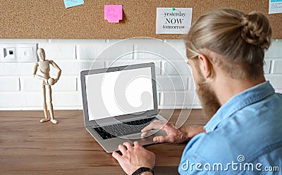 Young man using laptop e learning browsing internet with mock up blank screen. Stock Photo