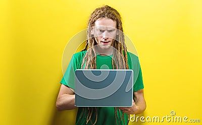 Young man using a laptop on a solid background Stock Photo