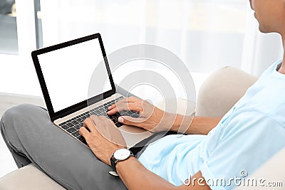 Young man using modern computer, focus on hands. Space for design Stock Photo