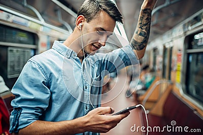 Young man using phone in metro, addicted people Stock Photo