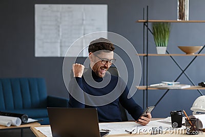 Young man using smartphone and smiling. Happy businessman using mobile phone apps, texting message, browsing internet Stock Photo