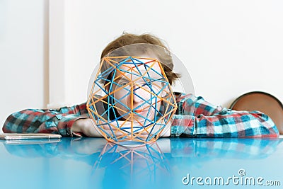 Young Man And The Volumetric Model Of Geometric Solid Stock Photo