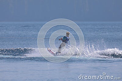 Young man wakeboarding on Cultus lake on a sunny day. Editorial Stock Photo