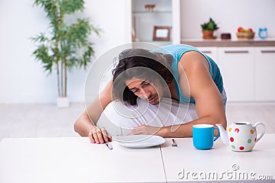 Young man waking up at home Stock Photo