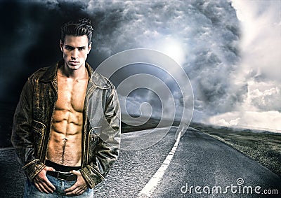 Young man walking down a road with very bad weather far away Stock Photo