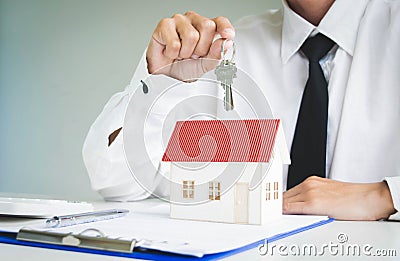 The young man was about to approve the money to rent a house and a car. Stock Photo