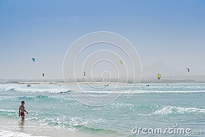 Young man in water Carlota beach kitesurfers in background Cape Editorial Stock Photo