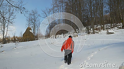 Young man wearing ski costume creating a footpath in the snow at the mountain stock video footage Young man wearing ski costume creating a footpath in the snow at the mountain stock video footage