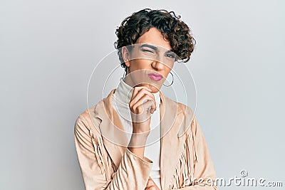 Young man wearing woman make up and woman clothes thinking concentrated about doubt with finger on chin and looking up wondering Stock Photo