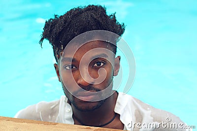 Young man wet shirt pool water swimming vacation Stock Photo