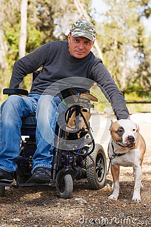 Young man in a wheelchair with his faithful dog. Stock Photo