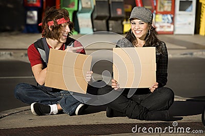 Young Man and Woman with Blank Cardboard Signs Stock Photo