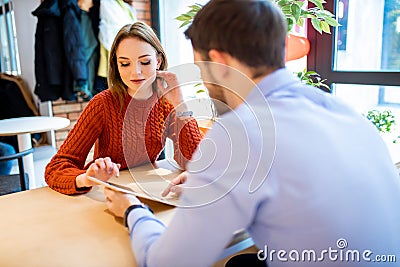 Young man and woman in cafe, using tablet Stock Photo