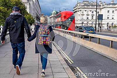 Young Man and Woman Couple Walking Accross Waterloo Bridge Holding Hands Editorial Stock Photo