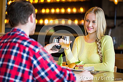 Young man and woman drinking wine in a restaurant. Young man and woman drinking wine on a date. man and woman on a date Stock Photo