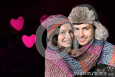 Young Man and Woman in His Arms on the Background of Hearts. Love Concept Stock Photo