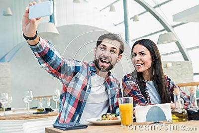 Young Man and Woman Sitting in the Restaurant Concept Stock Photo