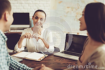 Young Man and Woman in Travel Agency with Manager. Stock Photo