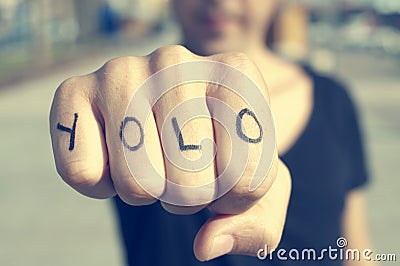 Young man with the word yolo, for you only live once, tattooed i Stock Photo