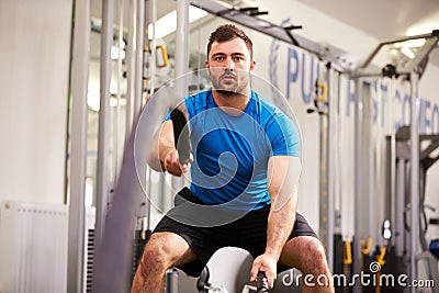 Young man working out with battle ropes at a gym Stock Photo