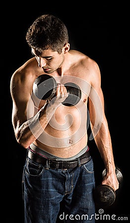 Young Man Working Out Biceps - Dumbbell Concentration Curl Stock Photo