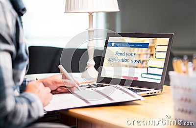 Young man writing college or university application form Stock Photo