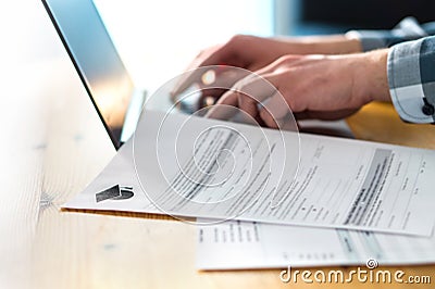 Young man writing college or university application form. Stock Photo