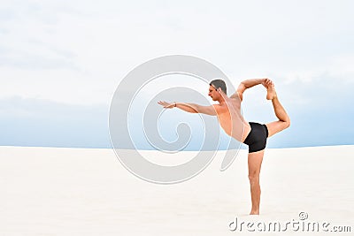 Young man in yoga pose natarajasana Stock Photo