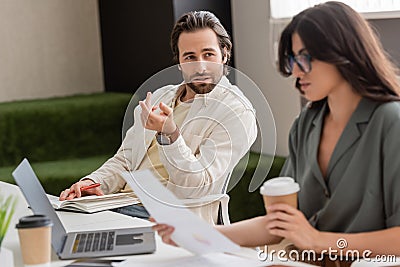 young manager talking to blurred businesswoman Stock Photo