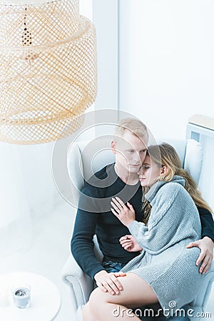 Young marriage relaxing on armchair Stock Photo