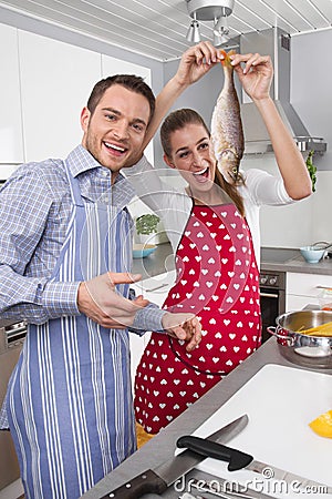 Young married couple in the kitchen - have fun and cooking fresh Stock Photo