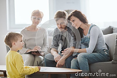 Young married couple with son during family therapy with counselor Stock Photo