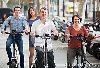 Young and mature couples staying with bikes outdoor Stock Photo