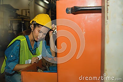 The young mechanic searches and validates the tools in the drawer. Stock Photo