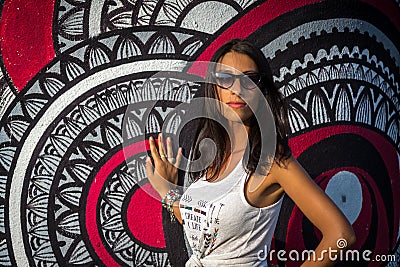 Young mediterranean girl in white tshirt posing near the wall Editorial Stock Photo