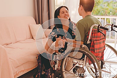 people with disabilities in home or nursery with family or volunteer with love and understanding Stock Photo