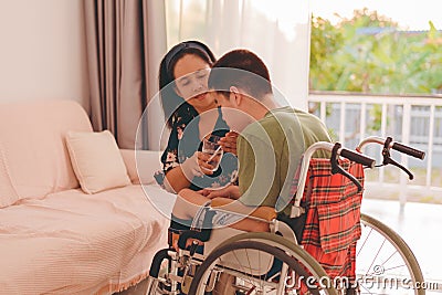 people with disabilities in home or nursery with family or volunteer with love and understanding Stock Photo